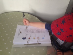 Practising his pencil grip by ticking off the checklist.